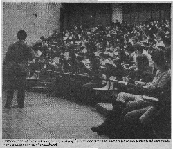 thumbnail of a photo of a large classroom full of students with a professor 
lecturing and the subtitle Long hours spent in class taking notes, studying for 
tests or exams and doing regular assignments all contribute to the endless nature 
of schoolwork